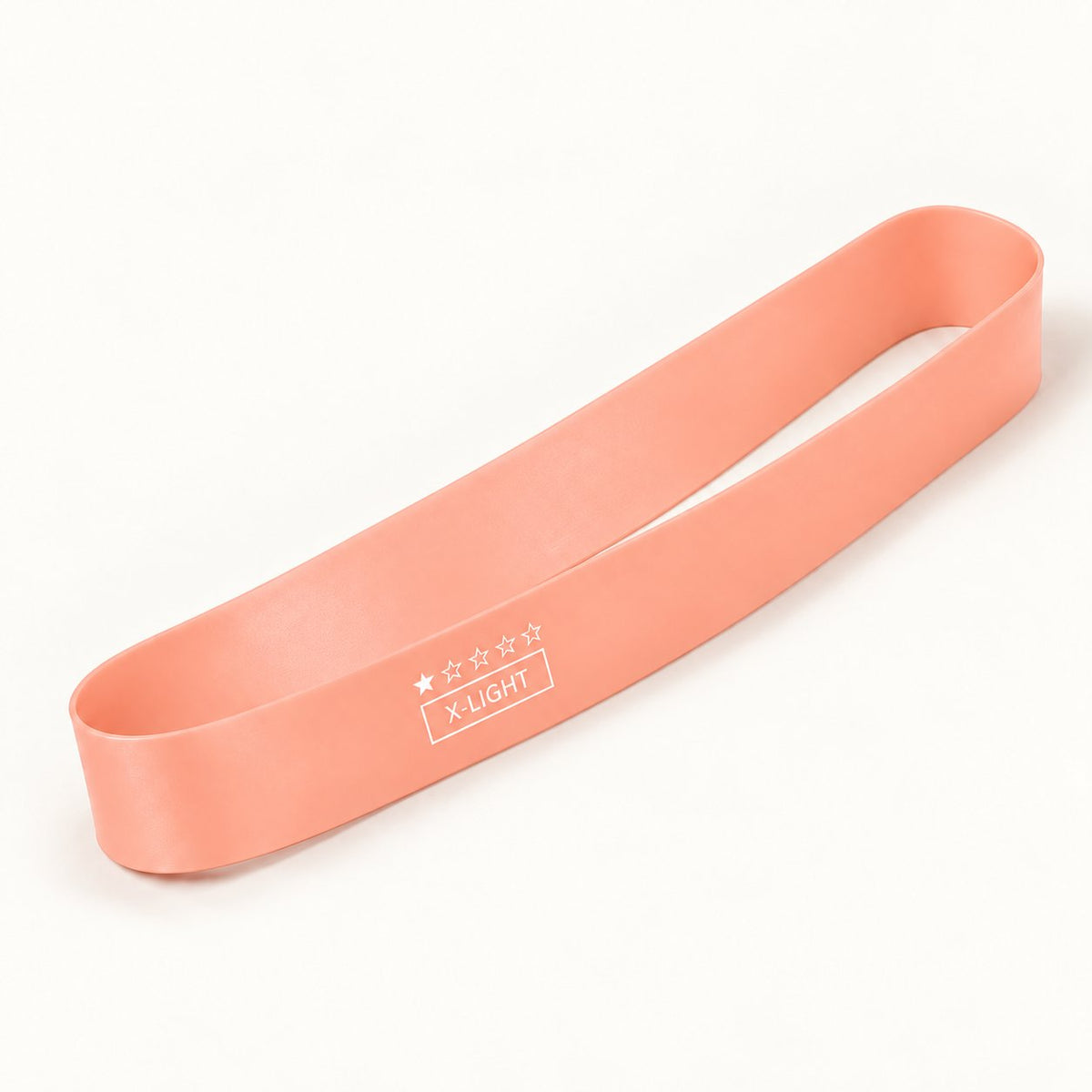 One tender pink natural latex resistance loop band, shown individually on an ivory background.